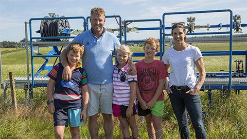 Gary and Penny Robinson with their children Harry, Charlie, and Olivia in front of their subsurface drip irrigation test paddock in Cust.